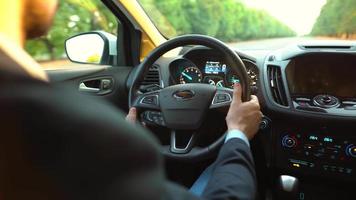 Man driving a car on the road in sunny weather and losing control during the ride. View from behind the driver video