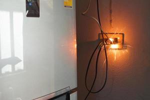 electrical plug sparking and burning Caused by a short circuit, concept, danger from using non-standard equipment, defective equipment photo