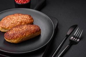 Delicious fried cutlets or meatballs from minced fish with spices and herbs photo