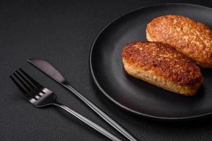 Delicious fried cutlets or meatballs from minced fish with spices and herbs photo