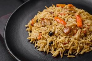 Delicious Uzbek pilaf with chicken, carrots, barberry, spices and herbs photo