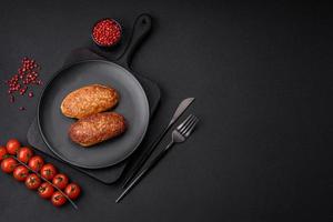 Delicious fried cutlets or meatballs from minced fish with spices and herbs photo