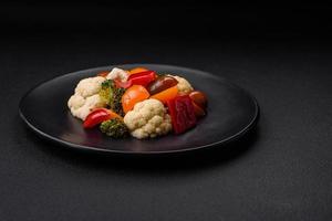 Delicious salad of fresh cherry tomatoes, sweet peppers, broccoli and cauliflower photo
