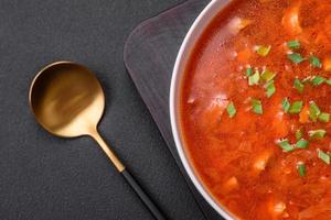 Delicious fresh Ukrainian borscht with beets, carrots and cabbage photo
