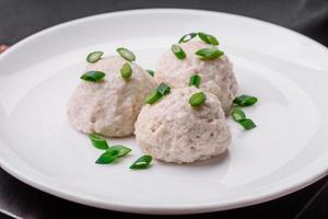 Delicious healthy steamed chicken cutlets or minced meatballs photo