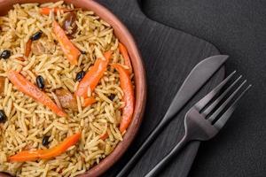 Delicious Uzbek pilaf with chicken, carrots, barberry, spices and herbs photo