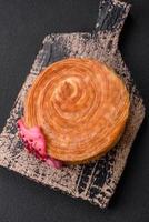 Round puff pastry croissant with raspberry filling or new york roll photo