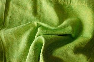 Texture, background, pattern. Texture of green wrinkled fabric. photo