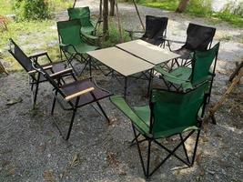 Camping chairs and portable table on the garden. photo