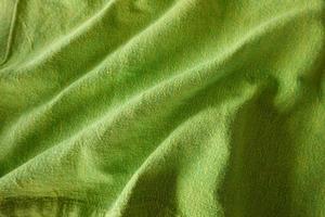 Texture, background, pattern. Texture of green wrinkled fabric. photo
