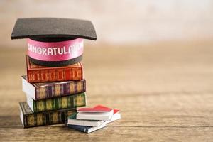 Graduation hat on book with copy space, learning university education concept. photo