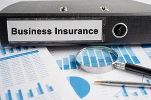 Business Insurance. Binder data finance report business with graph analysis in office. photo