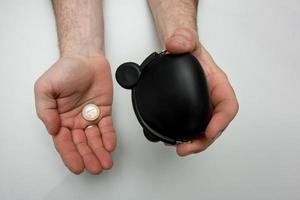 one last coin falls from a purse into a man's hand, a crisis photo