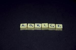 Alphabet english word with advice saying or spelling photography. Word block isolated on dark horizontal black background. Simple business image themed idea concept photo. photo