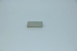 A couple of two small magnet bar with rectangle shape. Isolated object photo on white background.