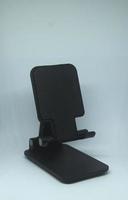 Black plastic phone stand object isolated on white background photo