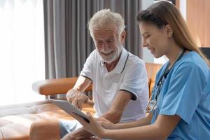 Elderly man talk to doctors and nurses in the hospital. senior male happy after receiving treatment and care and practice walk from a professional doctor. health care, physical therapy, nursing home photo