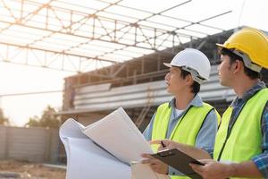 Engineers use blueprint check construction on site. Contractor and inspector inspection construction during project.civil Forman check quality assurance. Audit, inspect, quality control. photo