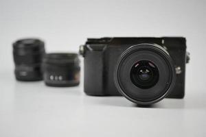 a black color mirrorless camera and lens on white background photo