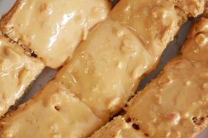 top view of peanut butter and a bread on plate on black background photo