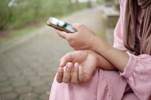 close up of women hand holding smart phone photo