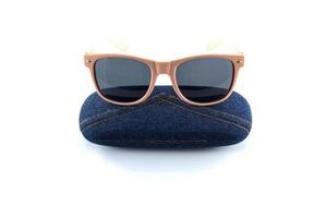 pink sunglasses in jean case on white background photo