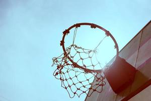 Wooden basketball hoop during sunset. photo