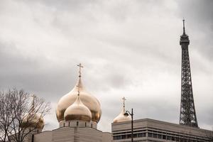 Close up view of The Eiffel Tower head  with golden dome mosque. photo