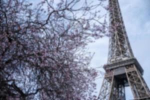 Blur Photo Spring in Paris. Bloomy cherry tree and the Eiffel Tower.