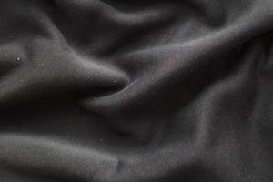 black wrinkled plush fabric background texture, soft material pattern photo