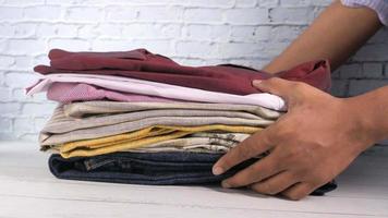 close up of stack of clothes on table video