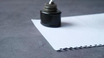 ink, empty paper and fountain pen on table video