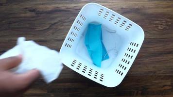 Disposing of a used mask and tissue in the trash video