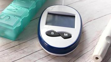 Close up of diabetic measurement tools and pill box on table video