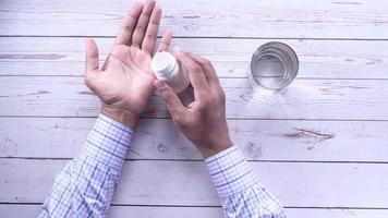 man hand taking pill from a pill box video
