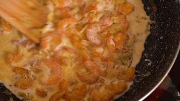 Cooking shrimp in garlic-cream sauce closeup video