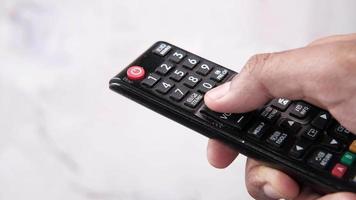 Close up of man hand holding tv remote video