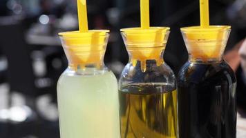 bottle of olive oil , lemon and soya sauce on table video