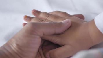 father holding hand of baby child, close up . video