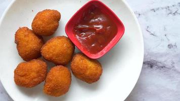 close up of chicken cheese meat ball on plate . video