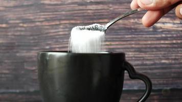 pouring white sugar in a coffee cup video