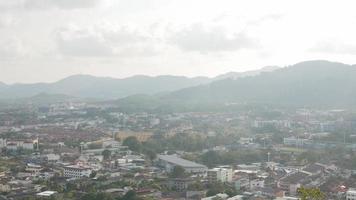 aerial view of phuket town city with background of bay and beach and mountain hill range under sunny sunshine sky daytime video