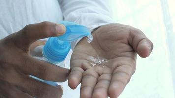 Close up of man hand using sanitizer gel isolated on black video