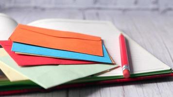 Colorful envelope and notepad on wooden table video