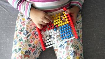top view of child playing with abacus toy., video