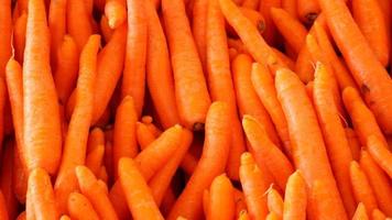Fresh clean carrots on shelf in farmer market video