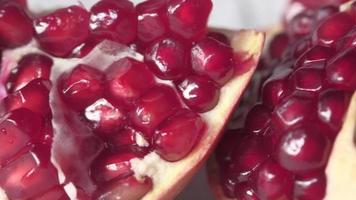 slice of a pomegranate on white background video