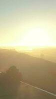 Aerial view of hazy morning light over green rural landscape video