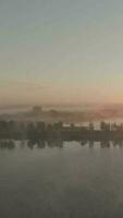 Aerial view of hazy morning light over green rural landscape video