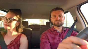 Beautiful couple rides in a car and admires the surrounding views video